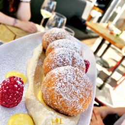 a plate of doughnuts and raspberries