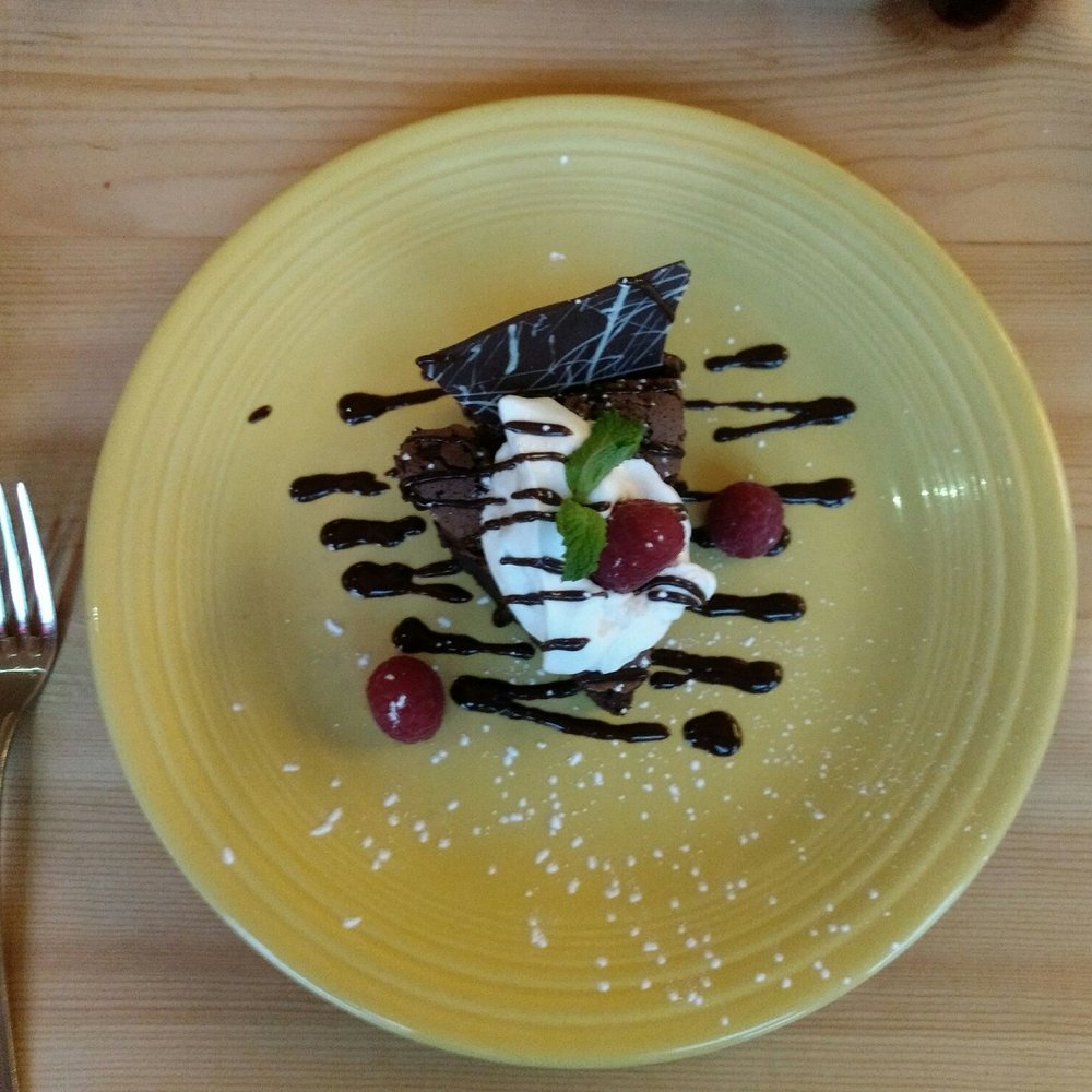 Saute' on 6th - Flourless chocolate cake. Don't let the small size fool you... This baby is RICH. Shared with the hubs. - New American Near Me - Clarkston, Washington Saute' on 6th - Flourless chocolate cake. Don't let the small size fool you... This baby is RICH. Shared with the hubs. - New American Near Me - Clarkston, Washington