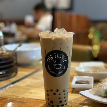 Photastic - a glass of iced coffee on a table - Vietnamese Near Me - Miami, Florida