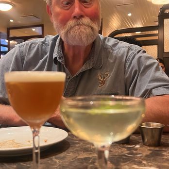Dishoom - My father being silly over cocktails. Pictured: whiskey sour and India gimlet - Indian Near Me - Kensington, XGL Dishoom - My father being silly over cocktails. Pictured: whiskey sour and India gimlet - Indian Near Me - Kensington, XGL