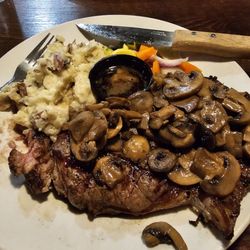 69 Steak House - Grilled 16oz Ribeye steak with garlic mashed potatoes sautéed mushrooms and assorted vegetables