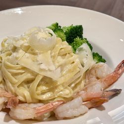 Mangino's - Pasta and shrimp homemade cheese melted on top.  Employee comes to your table to make.  Cheese from Italy.