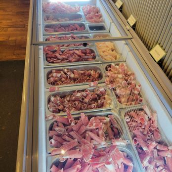 DAM-A - Frozen hot pot meat options. Tongs were included at the end of the bar - Korean Near Me - Austin, Texas