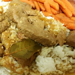Pork adobo over rice with cooked carrots. Pork adobo over rice with cooked carrots.