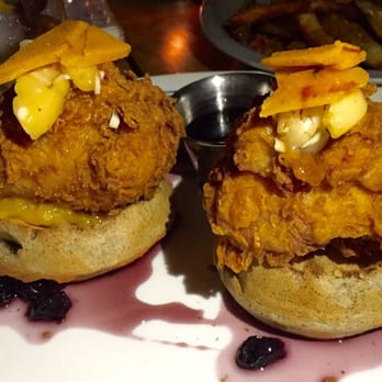 Proof - Fried chicken and waffles topped with peach compote bacon brittle and smoked blueberry syrup - American Near Me - Scottsdale, Arizona Proof - Fried chicken and waffles topped with peach compote bacon brittle and smoked blueberry syrup - American Near Me - Scottsdale, Arizona