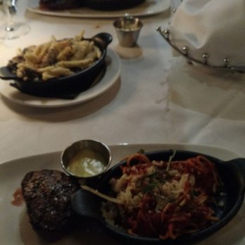 Delmonico's Steakhouse - Closer: filet mignon with spaghetti Middle:truffle Mac and cheese Further: ribeye with the added onion and mushroom and spaghetti - Steakhouses Near Me - Independence, Ohio