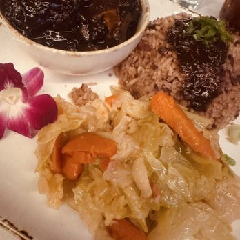 Status Hollywood - Oxtail entree with braised cabbage and rice and peas. - Seafood Near Me - Los Angeles, California Status Hollywood - Oxtail entree with braised cabbage and rice and peas. - Seafood Near Me - Los Angeles, California