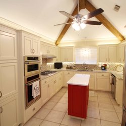Showcase Homes & Remodeling - Beautiful bright kitchen with red accent island.