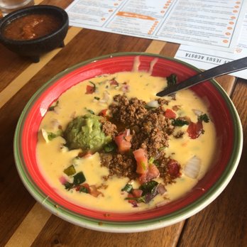 Mesa Mexican Cuisine - A bowl of Roberto's queso. Taco meat, guacamole and pico de gallo on Mesa queso - Mexican Near Me - Grapevine, Texas Mesa Mexican Cuisine - A bowl of Roberto's queso. Taco meat, guacamole and pico de gallo on Mesa queso - Mexican Near Me - Grapevine, Texas