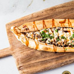 Paramount Middle Eastern Kitchen - Dive into flavor paradise with Paramount Fine Foods' Cheesy Beef Shawarma Boat  A delectable journey of seasoned beef shawarma, tangy pick