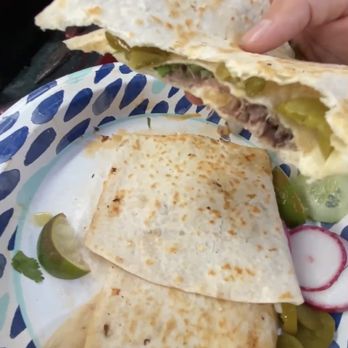 Las Favoritas - a person holding a plate of quesadillas - Food Trucks Near Me Las Favoritas - a person holding a plate of quesadillas - Food Trucks Near Me
