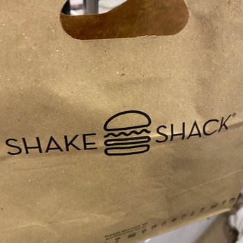 Shake Shack West Midtown - a paper bag with a burger inside - Burgers Near Me - Atlanta, Georgia Shake Shack West Midtown - a paper bag with a burger inside - Burgers Near Me - Atlanta, Georgia