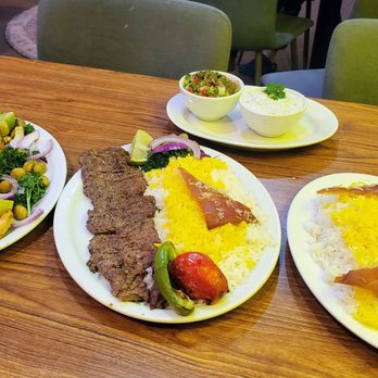 The Persian Grill House - Kabab Plater (left), Barg Kabab (center), Basmati Saffron rice w/ Tadig (right), Shirazi and Maast-o-khiar (top), and Doogh (drink). - Persian/Iranian Near Me - Victoria, British Columbia The Persian Grill House - Kabab Plater (left), Barg Kabab (center), Basmati Saffron rice w/ Tadig (right), Shirazi and Maast-o-khiar (top), and Doogh (drink). - Persian/Iranian Near Me - Victoria, British Columbia