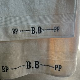 Towels with barbed wire accents to western style lettering Towels with barbed wire accents to western style lettering