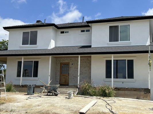 Complete Exterior Remodel - **Complete Exterior Remodel | Wine Country, Temecula**

This Wine Country home underwent a complete exterior transformation, combining timeless design with modern building practices to create a durable, low-maintenance exterior built to last.

The project began with the removal of the existing siding, allowing us to inspect the underlying structure and prepare the home for a brand-new exterior envelope. We installed over 20 new windows and doors, carefully integrating each opening with new weather-resistant barriers and flashing to ensure proper waterproofing and long-term performance.

With the home fully prepared, we installed a traditional three-coat stucco system over new weatherproofing paper, providing a solid, code-compliant foundation for the finish coat. The exterior was completed in an Omega 20/30 sand finish in White, creating a clean, elegant appearance that complements the surrounding Wine Country landscape while offering lasting durability.

To enhance the home's architectural character, we installed custom foam trim around each window and door, creating depth and definition throughout the façade. Rich custom wood entry doors provide a warm focal point, while carefully placed stone veneer accents add texture and visual contrast without overwhelming the design. Together, these elements create a balanced exterior that feels both sophisticated and welcoming.

This project required close attention to detail throughout every phase—from demolition and waterproofing to window integration, stucco installation, and finish work. Our goal was not only to improve the home's appearance but also to ensure every component worked together as a complete exterior system designed for long-term performance.

**Scope of Work**

* Removal of existing exterior siding
* Installation of 20+ new windows and doors
* Installation of new weather-resistant barrier and waterproofing
* Traditional three-coat stucco system
* Omega 20/30 sand finish in White
* Custom foam trim installation
* Stone veneer accent installation
* Custom wood entry doors
* Complete exterior finish integration
* Jobsite protection, cleanup, and final detailing

At El Canyon Stucco, we believe a successful exterior renovation is about more than aesthetics. Proper preparation, quality materials, and attention to detail at every stage ensure the finished product performs just as well as it looks. This Temecula Wine Country remodel is a great example of how thoughtful design and quality craftsmanship can completely transform the appearance, value, and longevity of a home.