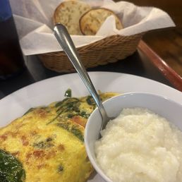 Veggie omelette and grits with English muffin. Veggie omelette and grits with English muffin.