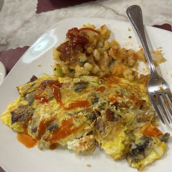 Nyack Diner - Nyack Omelette - Omelette with vegetables and sauce on a white plate, with mashed potatoes and gravy in the background at Nyack Diner. - Breakfast & Brunch Near Me - Nyack, New York