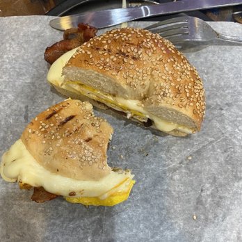 Nuno's Cafe - Egg sandwich on a sesame bagel with cheese and bacon - Breakfast & Brunch Near Me - Orlando, Florida Nuno's Cafe - Egg sandwich on a sesame bagel with cheese and bacon - Breakfast & Brunch Near Me - Orlando, Florida