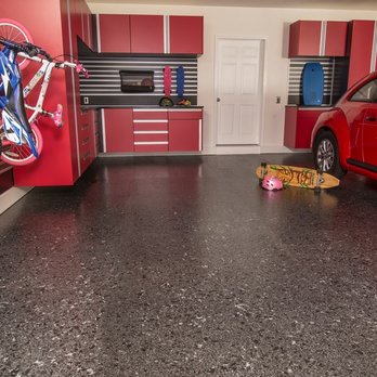 Garage Experts - a red car in a garage - Cabinetry Near Me
