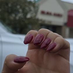 Brava Nails Spa - I requested Short almond nails, the image does no justice. The nail polish is saturated and the nails are an awkward oval shape.