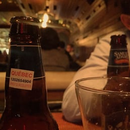a beer bottle and a glass on a table a beer bottle and a glass on a table