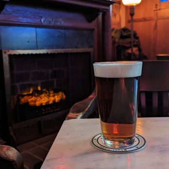 Cooney's Tavern - a pint of beer on a table - Pubs Near Me - Des Moines, Iowa