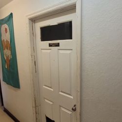Deltona Ice Cream - Employee kitchen entrance door with holes cut in the top and bottom for some reason.