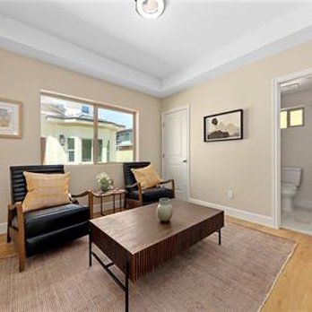 Nexhome Design - a living room with a couch and a coffee table - Painters Near Me Nexhome Design - a living room with a couch and a coffee table - Painters Near Me
