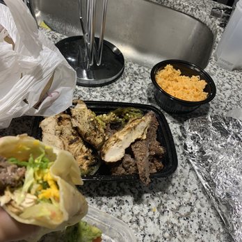 Fajita Pete's - Firethorne - a hand holding a burrito - Tex-Mex Near Me - Katy, Texas