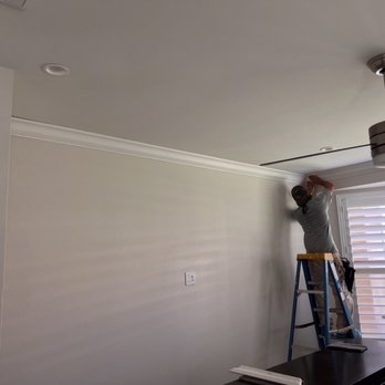 Smith Painting - a man working on a ceiling fan - Painters Near Me Smith Painting - a man working on a ceiling fan - Painters Near Me