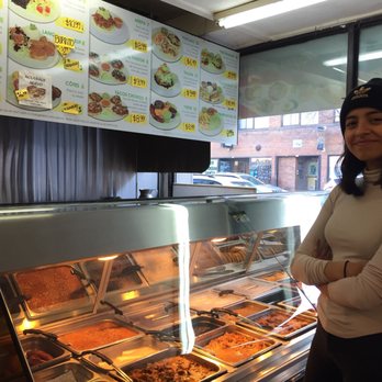 Sabor Latino - a woman standing in front of a buffet - Latin American Near Me - Montreal, Quebec Sabor Latino - a woman standing in front of a buffet - Latin American Near Me - Montreal, Quebec