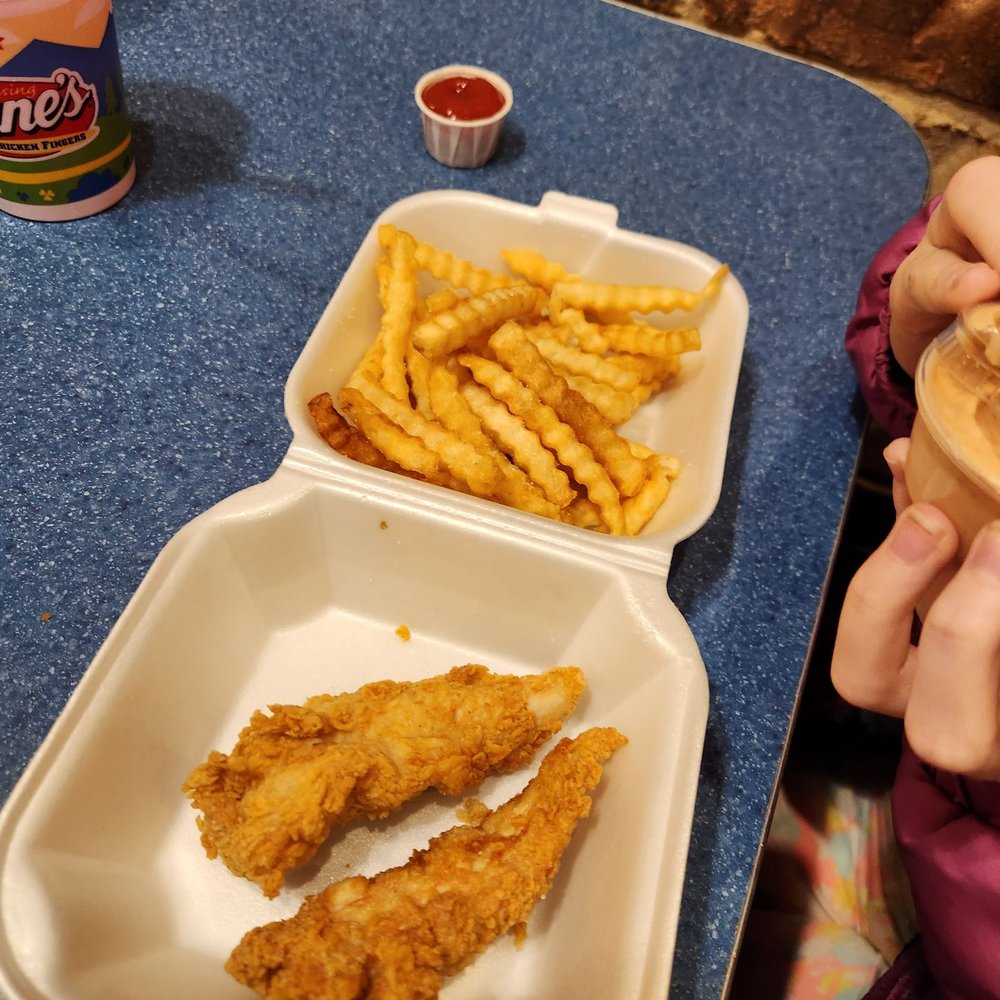 Raising Cane's Chicken Fingers - a child eating a sandwich and french fries - Chicken Wings Near Me - Columbus, Ohio Raising Cane's Chicken Fingers - a child eating a sandwich and french fries - Chicken Wings Near Me - Columbus, Ohio