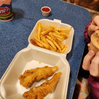 Raising Cane's Chicken Fingers - a child eating a sandwich and french fries - Chicken Wings Near Me - Columbus, Ohio