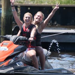 Wilmington Jet Ski Rentals - Two friends having fun on jet skis, their laughter and the splash of waves highlighting their adventure.