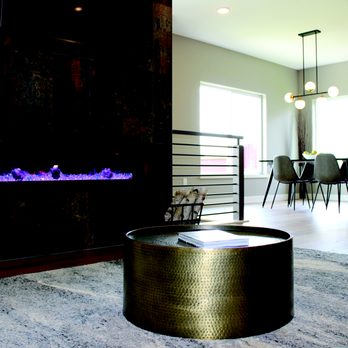 Randy's Flooring - a living room with a fireplace - Carpeting Near Me - Cedar Rapids, Iowa