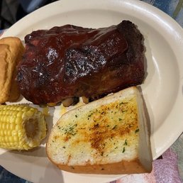 Baby-back ribs meal with cornbread and corn on the cob. Baby-back ribs meal with cornbread and corn on the cob.