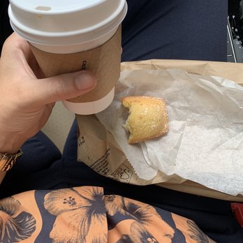 Hungry Ghost Coffee - a person holding a cup of coffee - Coffee & Tea Near Me - Brooklyn, New York