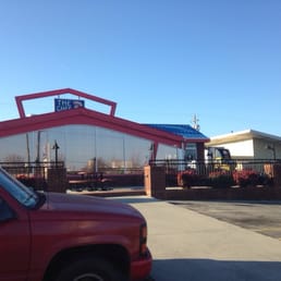 a red truck parked in front of a restaurant a red truck parked in front of a restaurant