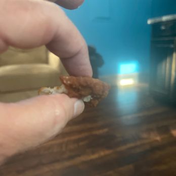 Chick-fil-A - ows a hand holding a piece of food - Fast Food Near Me - Matthews, North Carolina