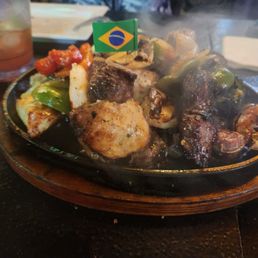 Picanha platter with chicken, steak, and shrimp skewers.