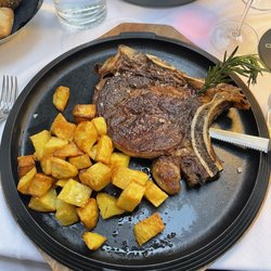 Vintage - Steak with potatoes served on hot cast iron plate
