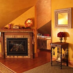 Steever House Bed & Breakfast - Attic Suite fireplace with whirlpool tub in the background.