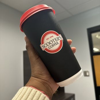 Scooter's Coffee - a hand holding a coffee cup - Coffee & Tea Near Me - Overland Park, Kansas Scooter's Coffee - a hand holding a coffee cup - Coffee & Tea Near Me - Overland Park, Kansas