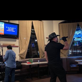 Schooner Bar & Grill - a man holding a baseball bat - Sports Bars Near Me - Redondo Beach, California Schooner Bar & Grill - a man holding a baseball bat - Sports Bars Near Me - Redondo Beach, California