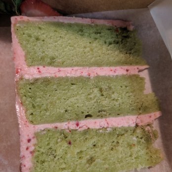 Syndesi Desserts - Slice of matcha cake with strawberry frosting - Custom Cakes Near Me