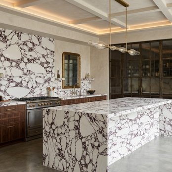 Verona Quartz Surfaces - Arabescato Viola quartz makes a striking statement in this open kitchen layout. Featured in of our 2026 natural quartz collection. - Building Supplies Near Me - Sun Valley, California Verona Quartz Surfaces - Arabescato Viola quartz makes a striking statement in this open kitchen layout. Featured in of our 2026 natural quartz collection. - Building Supplies Near Me - Sun Valley, California