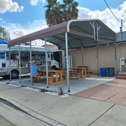 Benches, a car awning, and bathrooms in the vacant building.