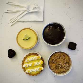 R&M Dessert Bar - Starting from Bottom Right Corner: Pear Buttermilk Cake, Lemon Mango Tart, Key Lime Tart, Triple Chocolate Cake - Desserts Near Me - Seattle, Washington R&M Dessert Bar - Starting from Bottom Right Corner: Pear Buttermilk Cake, Lemon Mango Tart, Key Lime Tart, Triple Chocolate Cake - Desserts Near Me - Seattle, Washington