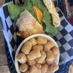Tater tots,  ham, bacon, cheese  croissant sandwich