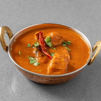 Red Onion - An aromatic mild chicken curry cooked in ground coconut and spices masala paste and garnished with fresh coriander. - Vegetarian Near Me - New York, New York Red Onion - An aromatic mild chicken curry cooked in ground coconut and spices masala paste and garnished with fresh coriander. - Vegetarian Near Me - New York, New York